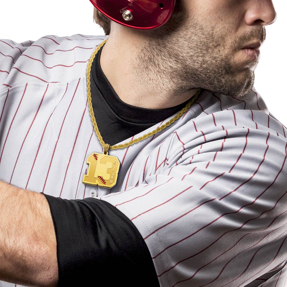 A man  is wearing a gold custom baseball sport number necklace with his name ETJAH engraved 